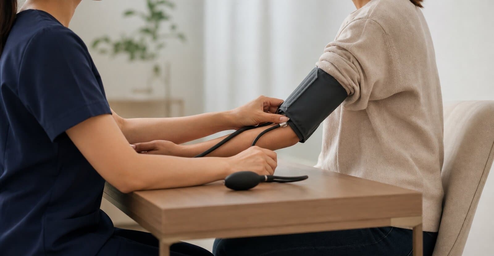 Clinician checking a patient's blood pressure during a supervised ketamine therapy session